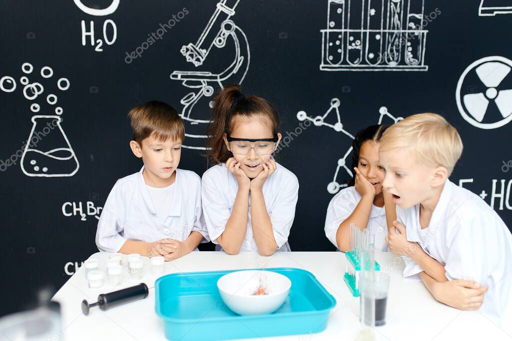 Group of kids and teachers carrying out a science experiment