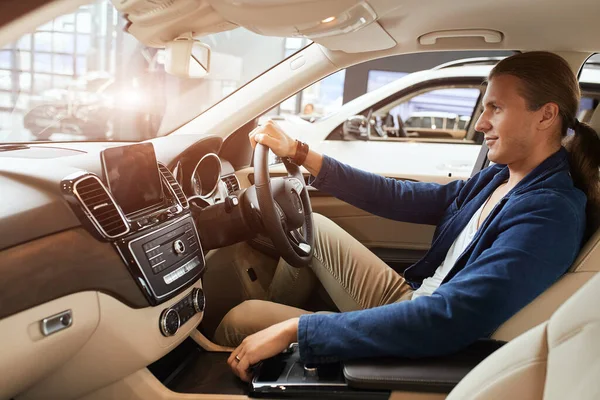 Elegant happy man in good new car in sale centre — Stock Photo, Image