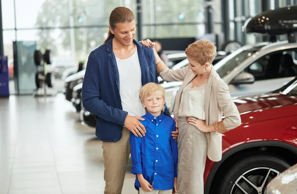 automobile sales centre. young family with child boy in car sell