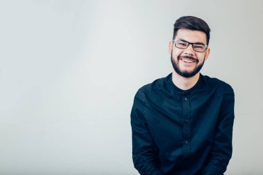 Yakışıklı genç adam kameraya bakıyor. Gülen genç adamın portresi