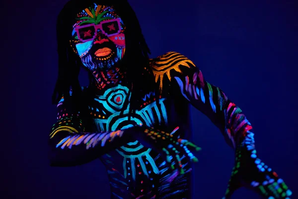 Cheerful cool fashion dancer in fluorescent body art — Stock Photo, Image