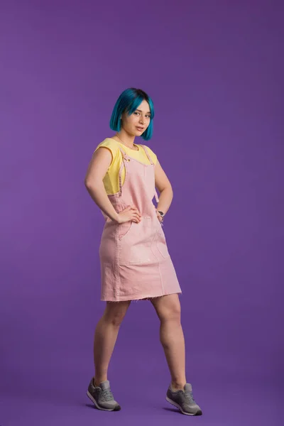 Girl with unusual style in clothes and dyed hair posing to the camera — Stock Photo, Image