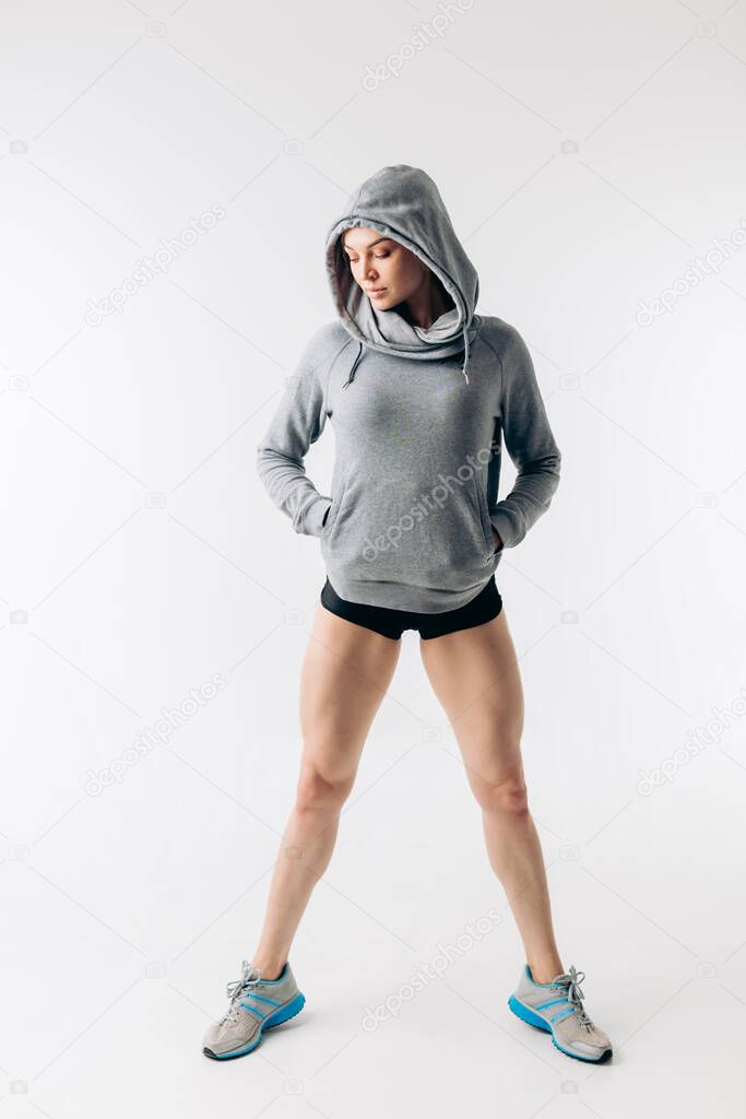 fashionable girl in sweatwear posing to the camera