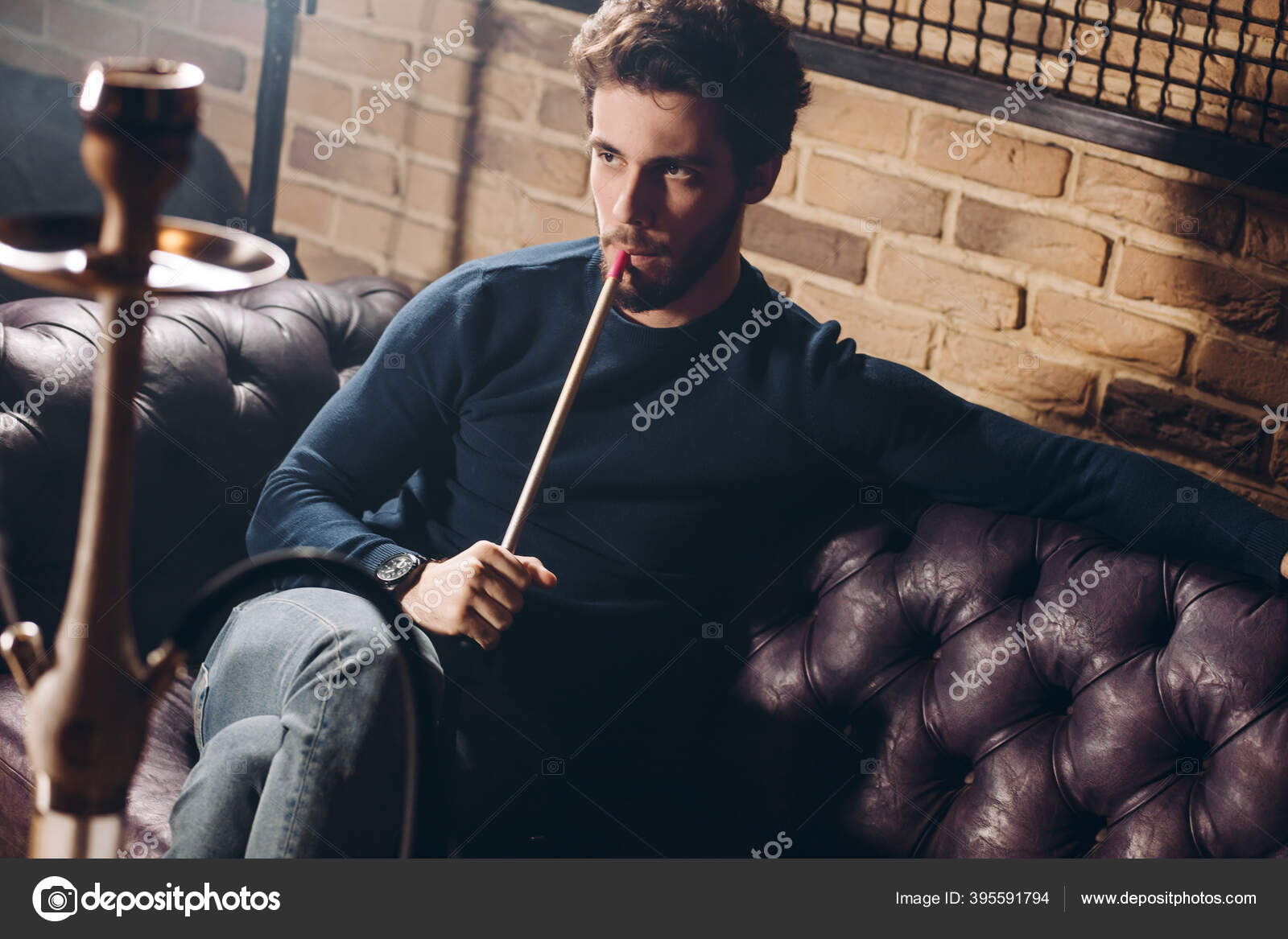 Young handsome serious bearded man smoking hookah indoors Stock Photo by  ©ufabizphoto 395591794