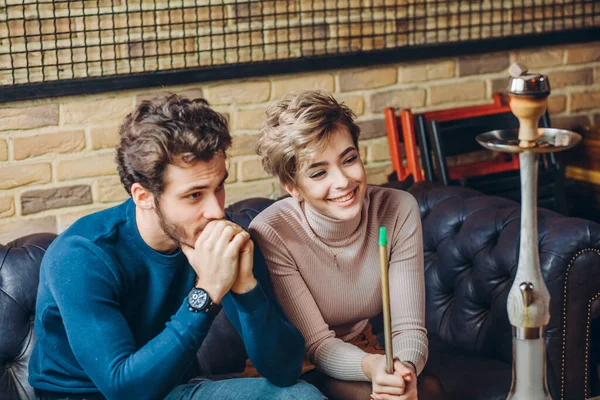 Cheerful couple in fashion clothes spending time in the cafe — Stock Photo, Image