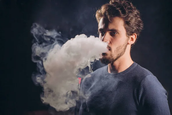 Caucasiano awesom homem está soprando fumaça — Fotografia de Stock