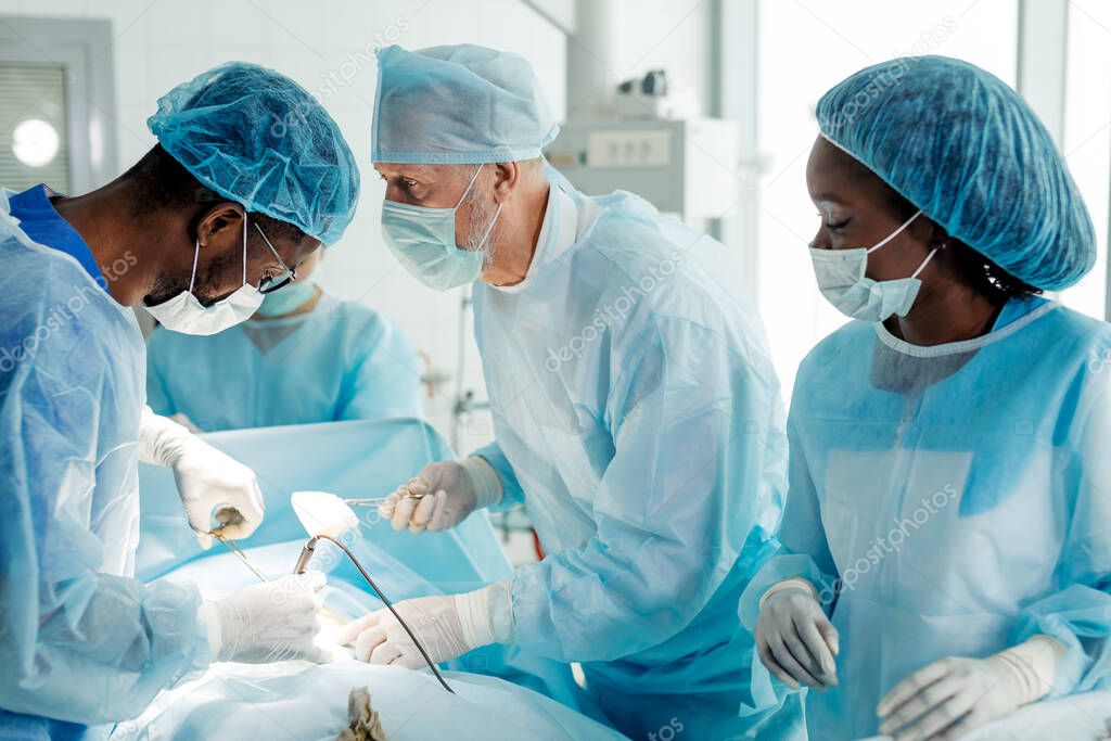 professional multiracial surgons specialize in cutting open the body