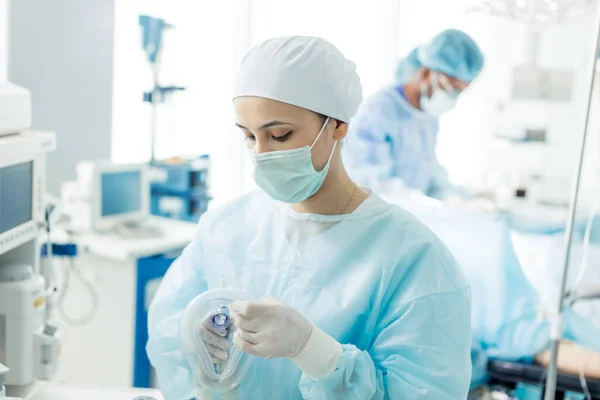 Enfermera atractiva preparando máscara de oxígeno para un paciente —  Fotos de Stock