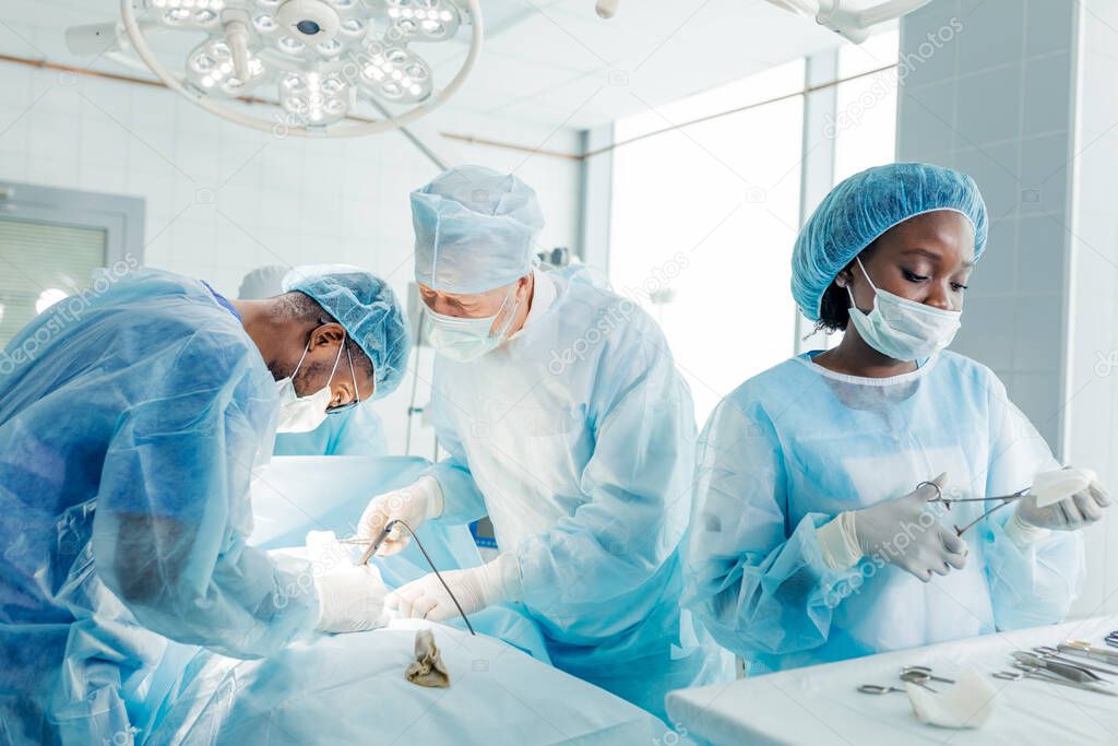multiracial doctors having the surgery.