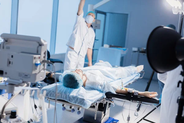 Team of anesthetists preparing patient for surgery at the operating room — Stock Photo, Image