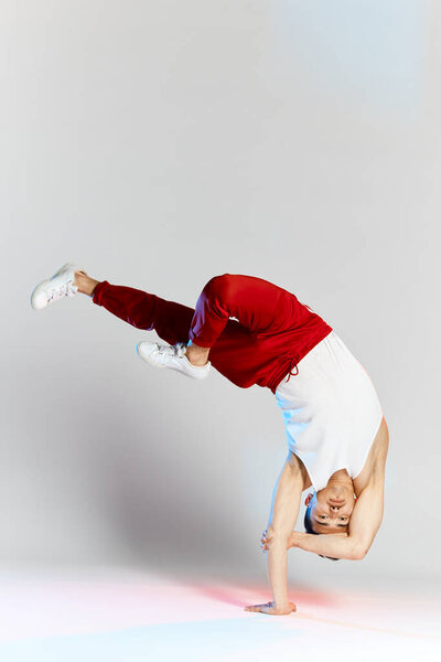 Asian personal break dancer trainer doing handstand on white background