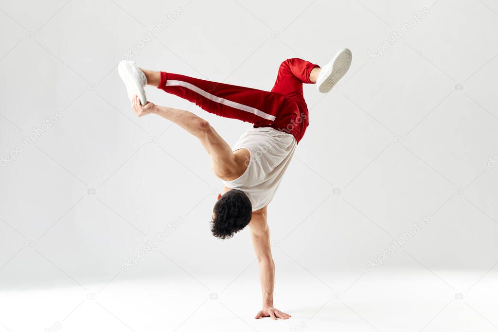 Modern dancer standing on one hand