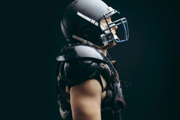 American football player with ball wearing helmet and protective shields — Stock Photo, Image