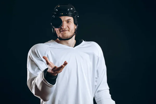 Joueur de hockey mord la rondelle avec les dents cassées et regardant la caméra avec un sourire. — Photo