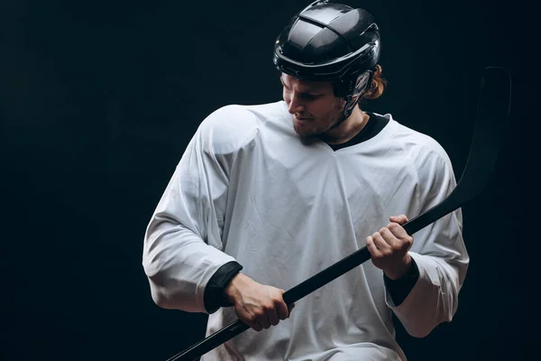 Beau joueur de hockey. Sourire à la caméra isolée sur fond noir. — Photo