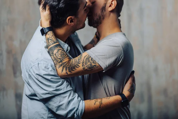 Cay couple enjoy togetherness indoors, kiss each other — Stock Photo, Image