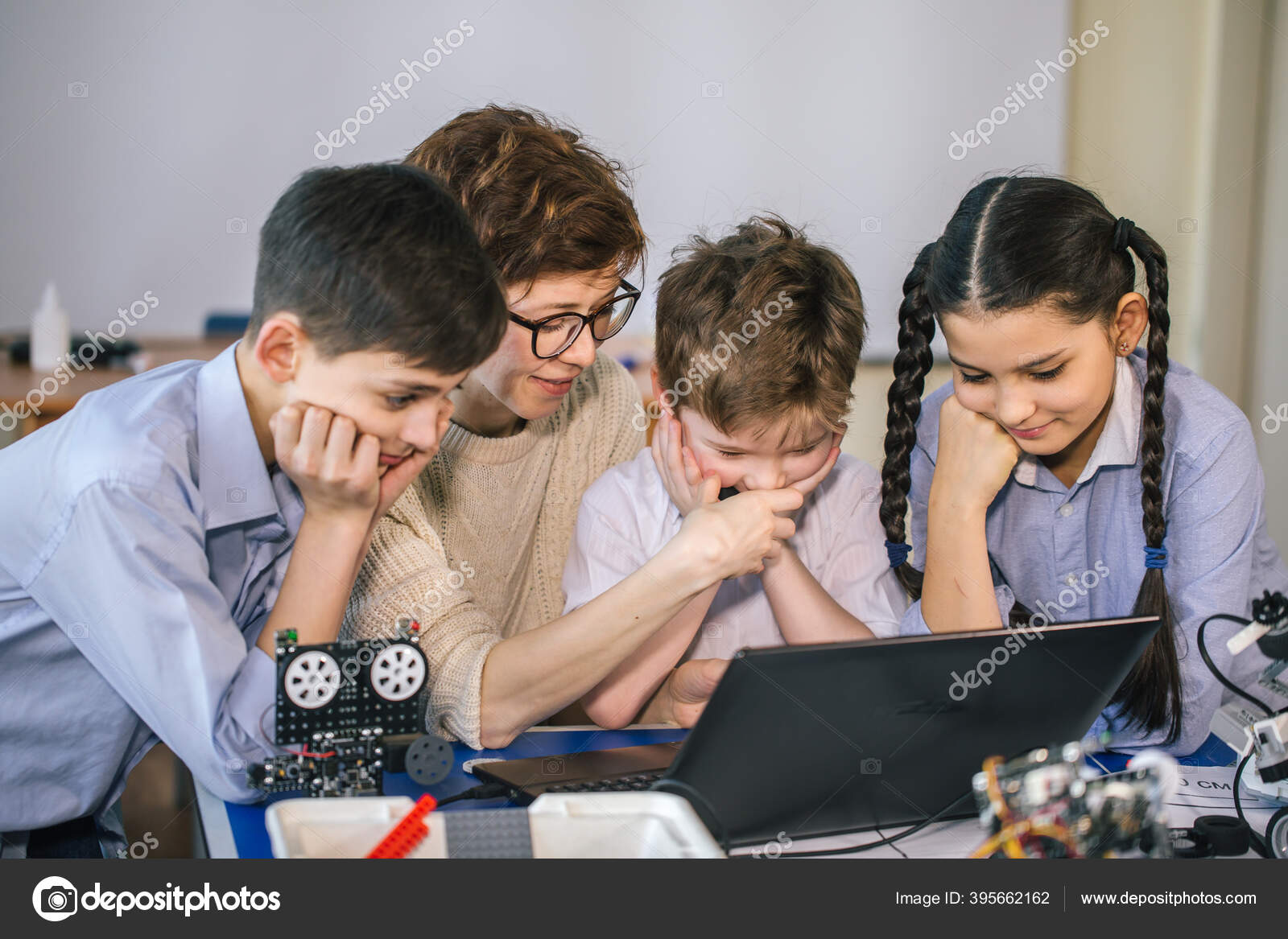 Happy children learn programming using laptops on extracurricular ...