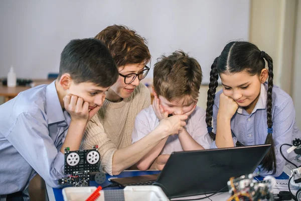 Glückliche Kinder lernen im außerschulischen Unterricht das Programmieren mit Laptops — Stockfoto