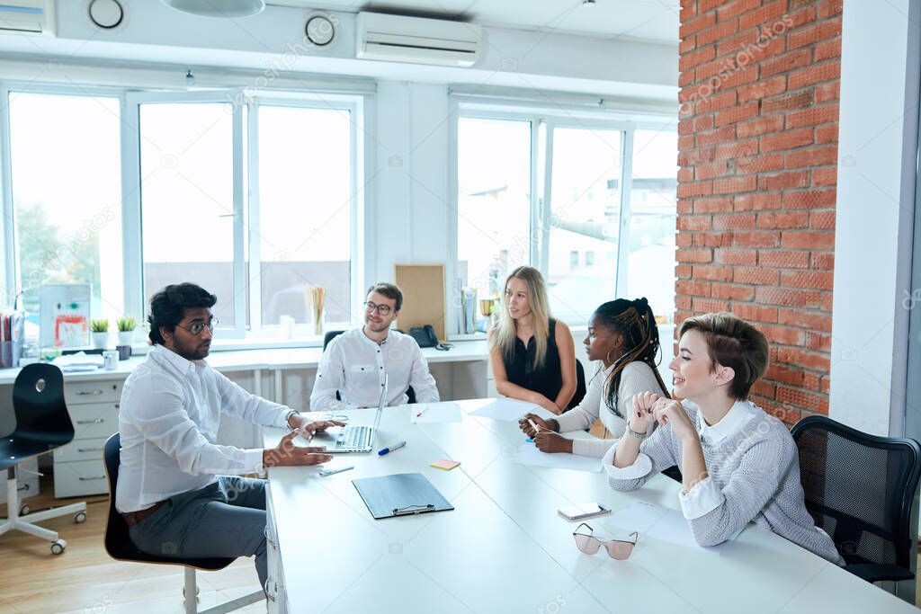 Successful mixed race young business people are talking during the coffee break