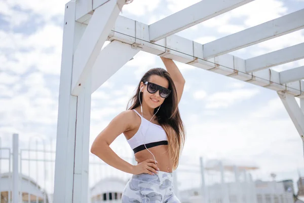 Mulher treinando ioga na praia ao pôr do sol — Fotografia de Stock