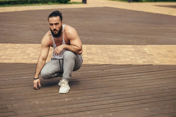 Homme athlétique avec le corps musculaire au repos après l'entraînement à l'extérieur — Photo