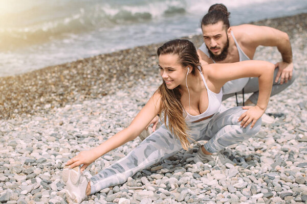 Stretching before everyday jogging on the beach