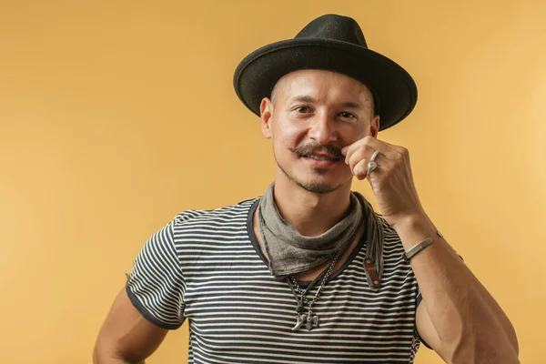 Happy man with moustache wearing hat isolated over yellow background. — Stock Photo, Image