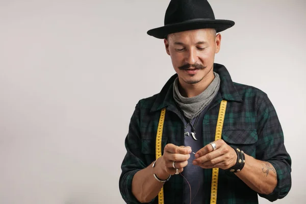 Zapatero con sombrero elegante y aguja de rosca de cinta métrica aislada en el estudio —  Fotos de Stock