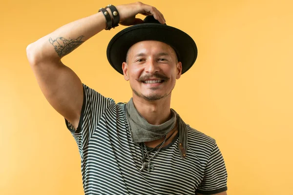 Happy man with moustache wearing hat isolated over yellow background. — Stock Photo, Image