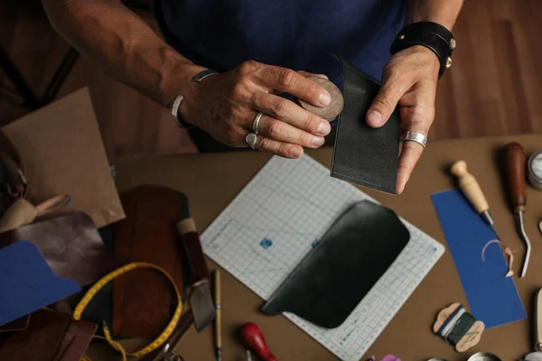 Working process of producing hand made leather wallet in the leather workshop.