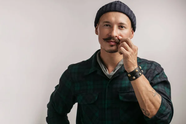 Smart professional expert handyman wearing knitted hat isolated in studio — Stock Photo, Image