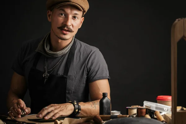 Professional shoemaker in hat isolated over white background — Stock Photo, Image