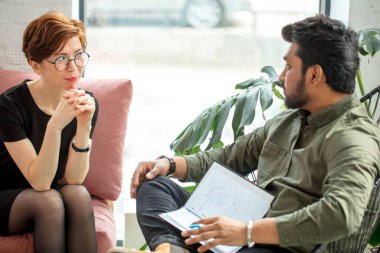 Psikiyatrist muayenehanesinde hastaya bakıyor.