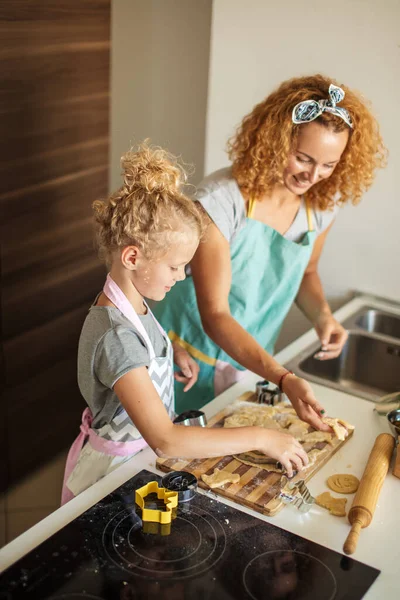 Dziecko i kobiety tnące formularz ciasteczka w cieście. Szczęśliwa rodzina i dzieciństwo. — Zdjęcie stockowe