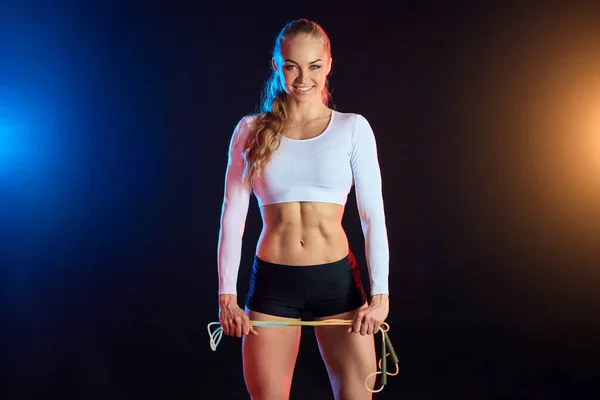 Sporty happy woman with skipping rope posing to the camera — Stock Photo, Image