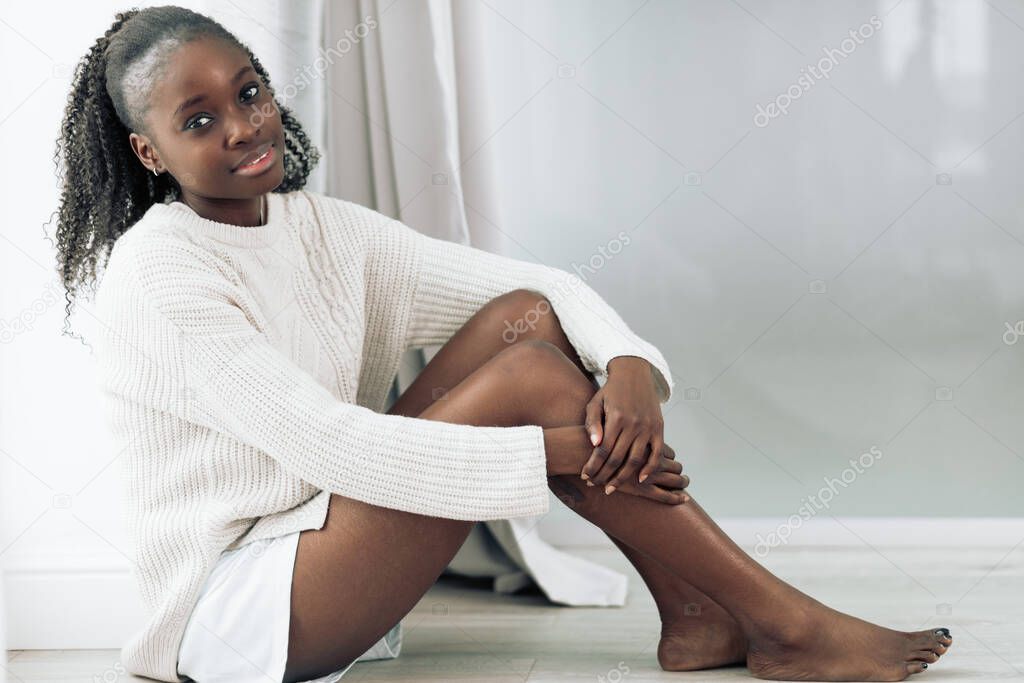 cheerful young afro american resting resting on the floor