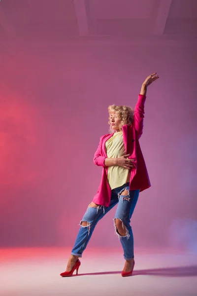 Dancer poses in front of studio background