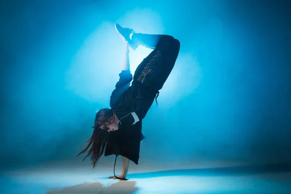 Mujer joven de moda bailando sola en el club, luz de neón, mucho humo. —  Fotos de Stock