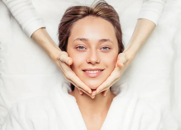 Time for myself. beautician massaging clients face for mask — Stock Photo, Image