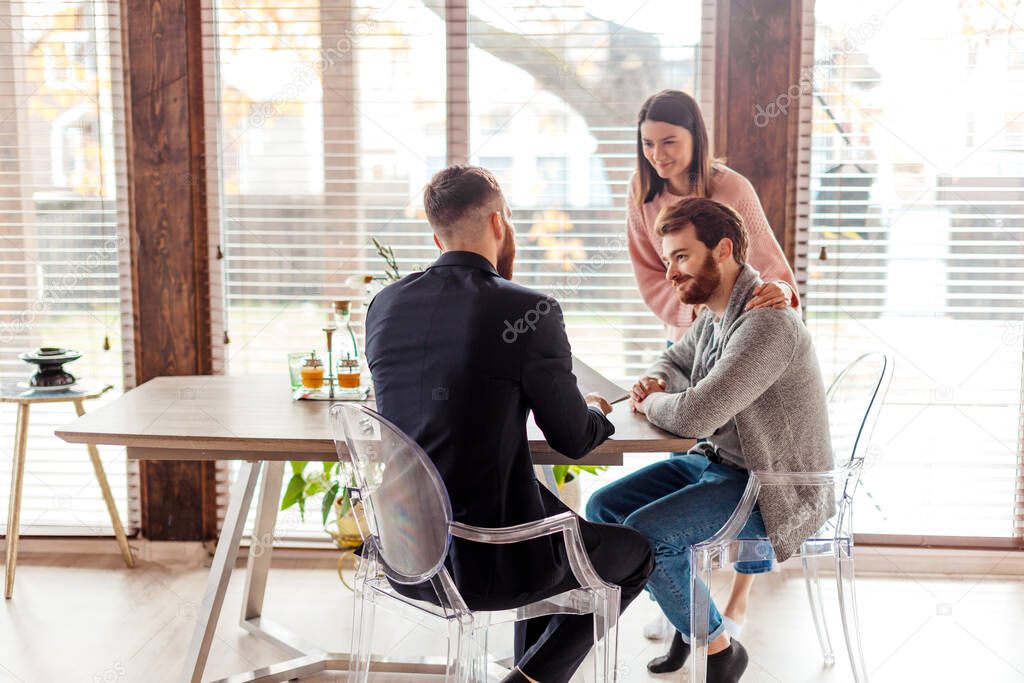 Family couple meeting with agent in office, buying, renting apartment or house.