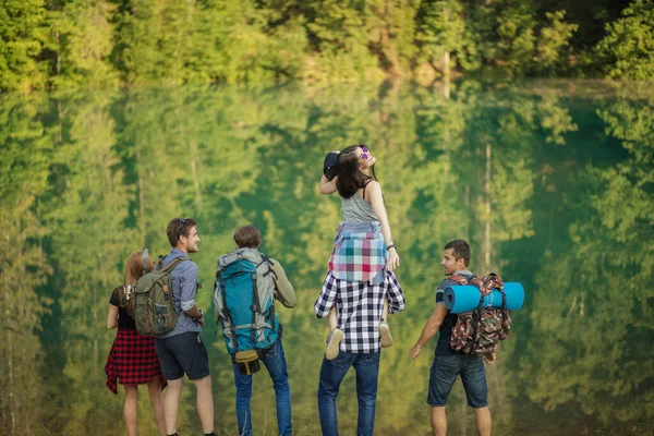 Impressionante ragazza è seduto su il suo amico e guardando il fotocamera — Foto Stock