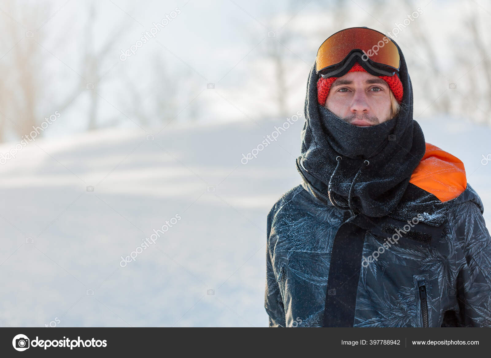 Young handsome man wearing ski mask and sport jacket loking at the