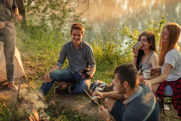 Attractive guy with camera is learning how to cut the stick Bushcraft concept — Stock Photo, Image