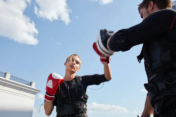 low angle view. closeup photo. sweaty tired girl throwing a punch