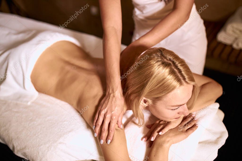Blonde girl resting in massage center