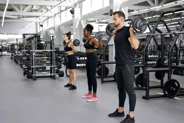 Olahragawan, kelompok multietnis melakukan latihan dengan bobot berat di gym — Stok Foto