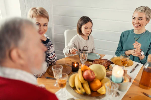 Smiling friendly people sitting at dining table