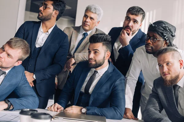 Multiracial group of business team consisting of men only with Executive indoor