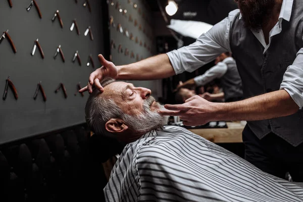 Vecchio ottenere la sua barba rasata dal barbiere — Foto Stock