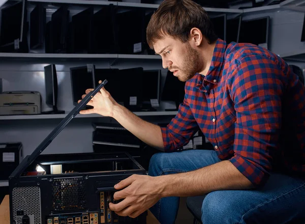 Serious man having problems with system unit — Stock Photo, Image